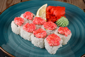 Rolls, wasabi, soy sauce, ginger on the table, avocado.