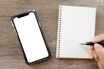 Flat lay of top view office table desk with blank notebook, smartphones ,Calculators and other office supplies as background Workspace and Work from home concept with copy space.