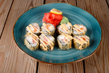 Rolls, wasabi, soy sauce, ginger on the table, avocado.