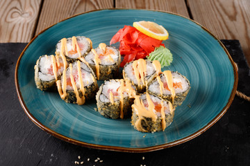 Baked sushi, rolls sprinkled with sesame seeds,