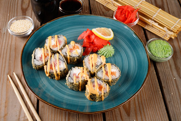 Baked sushi, rolls sprinkled with sesame seeds,