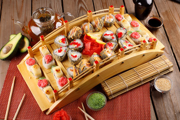 large colorful set of sushi in a square plate.
