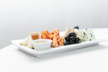 cheese slices on a white plate and a light background