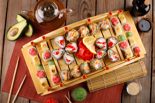 large colorful set of sushi in a square plate.