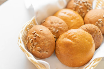 fresh buns in a basket on a white napkin