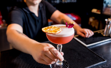 Bartender is making cocktail at bar counter. Fresh cocktails.