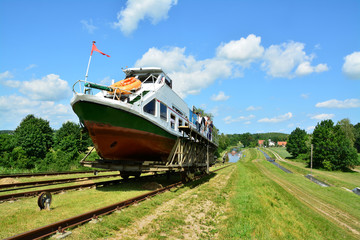Mechanical equipment for transporting boats, boat moored to the shore on the Elblag Canal, Poland