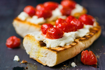 rustic italian bruschetta with caramelized cherry tomatoes and ricotta cheese