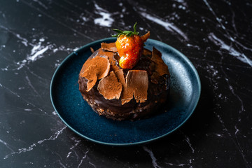 Turkish Dessert Polka Chocolate cake with Strawberry and White Cream from Local Patisserie in Plate for One Person Portion.