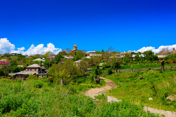 Beautiful Georgia mountain panorama with lush greens, blue skies, and puffy clouds