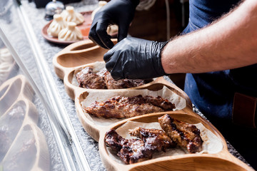 Chef cooking delicious beef and pork barbecue on grill. Georgian restaurant.