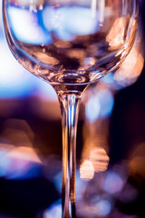 Wine and martini glasses in shelf above a bar rack in restaurant