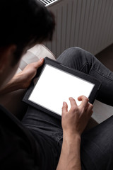 Teenage student is studying and surfing the internet using his tablet