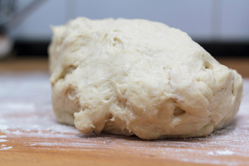 Raw dough on wooden board