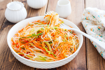 Funchoza salad with fresh cucumbers and Korean carrots, selective focus