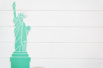 Statue of liberty on white wooden table with copy space