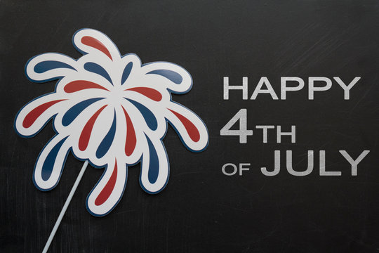 Firework props on blackboard with the text Happy 4th of July