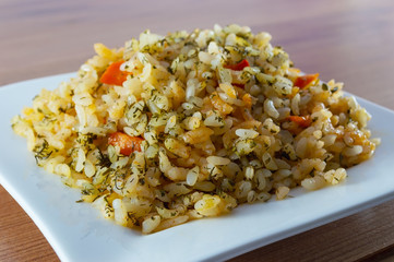 Rice with meat, vegetables and mushrooms on plate