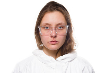 Fototapeta premium Portrait of young nurse in protective white medical uniform during coronavirus pandemic. Epidemic, pandemic of coronavirus covid 19.