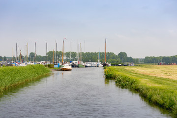 Little river at a harbour through the grasslands of  Warmond and Sassenheim in the Netherlands