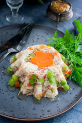Homemade aspic with chicken, pork peas with slices of carrots, selective focus