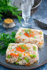 Homemade aspic with chicken, pork peas with slices of carrots, selective focus