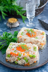 Homemade aspic with chicken, pork peas with slices of carrots, selective focus