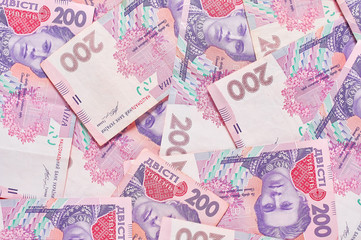 Fototapeta na wymiar Banknotes of ukrainian money signs on pink background. Payment of pensions, salaries. Bank loan. Business concept