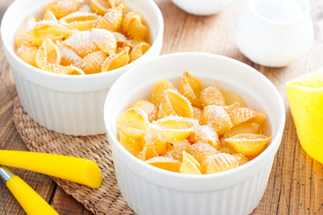 Pasta casserole with egg in white ceramic tins, selective focus
