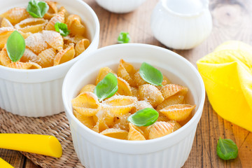 Pasta casserole with egg in white ceramic tins, selective focus