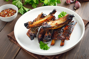 Grilled pork ribs on white plate