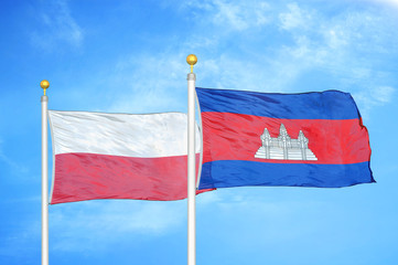 Poland and Cambodia  two flags on flagpoles and blue cloudy sky