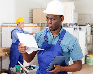 African-American builder reading document