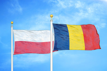 Poland and Chad  two flags on flagpoles and blue cloudy sky