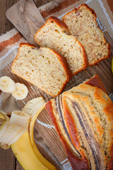 Homemade sliced banana bread on a wooden board, selective focus, top view
