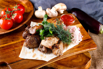 juicy fried chicken legs and meat with herbs accompanied by sauce and ingredients