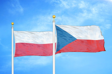 Poland and Czech Republic two flags on flagpoles and blue cloudy sky