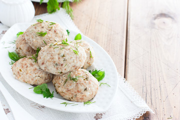 Dietary turkey cutlets on a white dish, horizontal, copy space