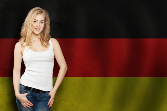 Travel in Germany concept. Pretty blonde woman against the Germany flag background