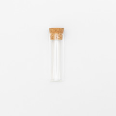 top view of transparent empty glass jar or test tube bottle with closed brown cork cap lids on white background