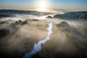 Aerial view of wonderful mist over river at sunrise