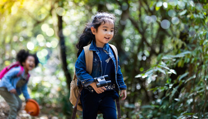 Children hiking in mountains or forest. Kids Camping summer. Two funny little girls having fun during forest hike on summer. Friend forever