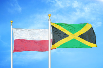 Poland and Jamaica two flags on flagpoles and blue cloudy sky