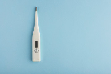 electronic thermometer on a blue background virus epidemic coronavirus protection