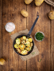 Portion of Fried Potatoes on an old wooden table (selective focus; close-up)