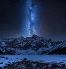 Milky way over Morskie Oko mountain lake in winter