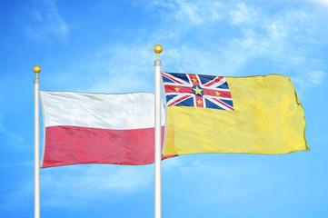Poland and Niue two flags on flagpoles and blue cloudy sky
