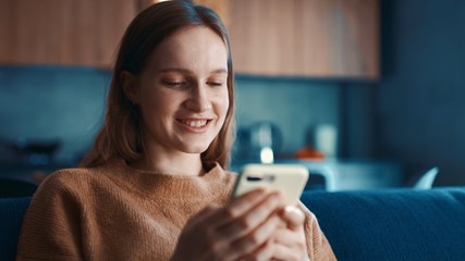 Portrait of caucasian woman texting with friends and surprised. Happy girl using phone and smiling