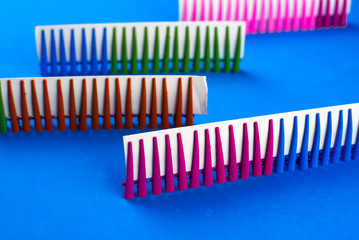 on a blue background hair clips of different colors in sets on a cardboard frame