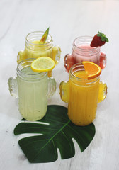 Natural juices of orange, lemon, pineapple, strawberry cactus-shaped glass